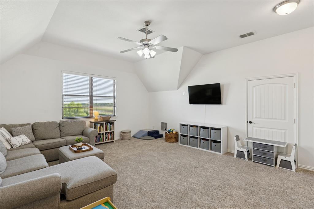 6824 Katie Corral Drive Fort Worth, TX 76126 - Photo 24 of 39 a living room with furniture and a flat screen tv
