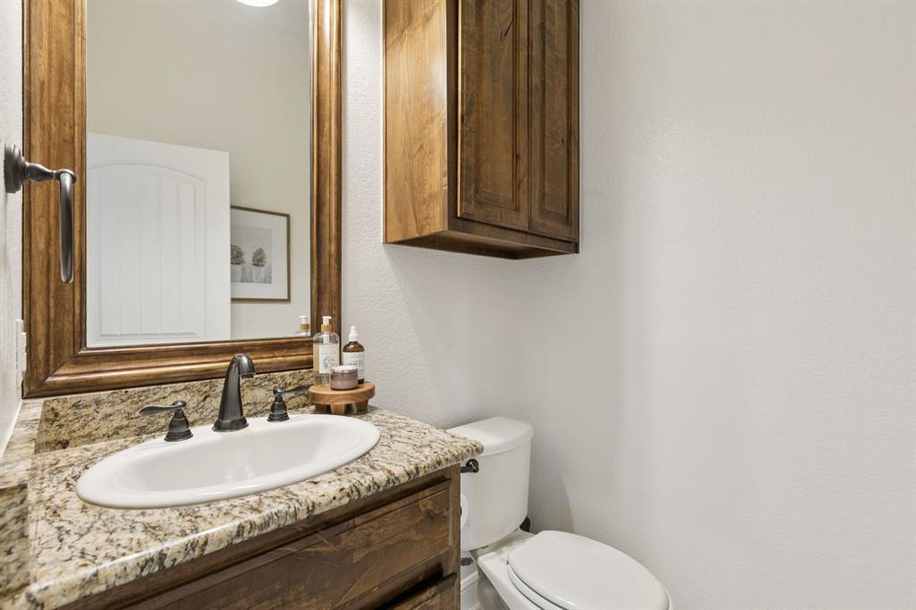 6824 Katie Corral Drive Fort Worth, TX 76126 - Photo 26 of 39 a bathroom with a granite countertop sink and a mirror