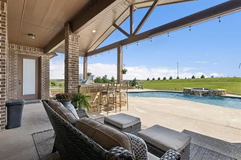 a view of a chairs and table in the balcony