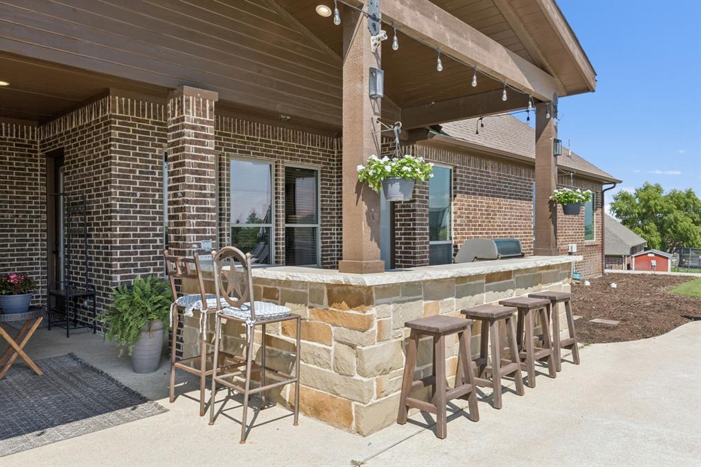 6824 Katie Corral Drive Fort Worth, TX 76126 - Photo 32 of 39 a view of a patio with table and chairs and potted plants