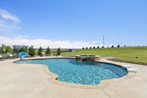 a view of a patio with a table and chairs