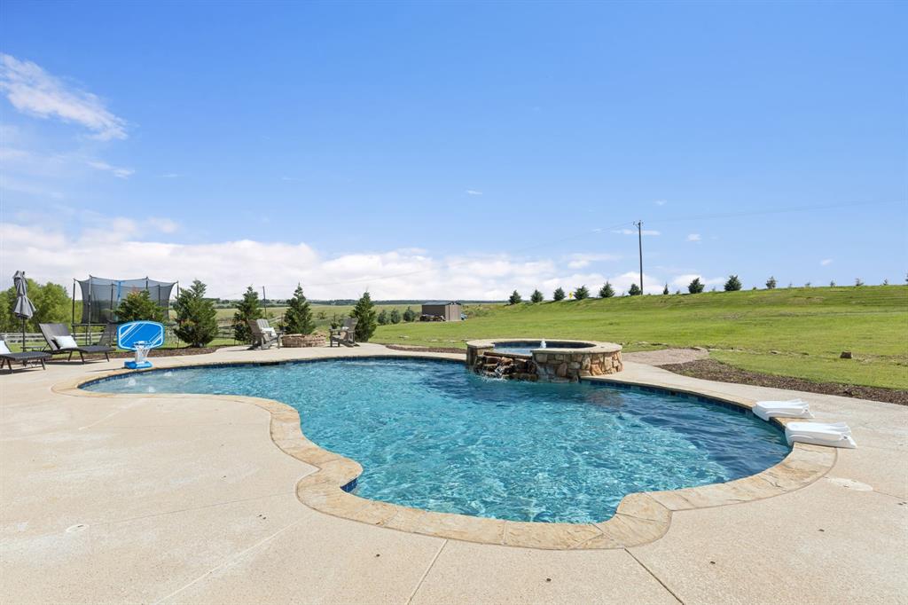 6824 Katie Corral Drive Fort Worth, TX 76126 - Photo 33 of 39 a view of a swimming pool and trees in the background