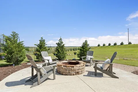 a front view of a house with a yard table and chairs