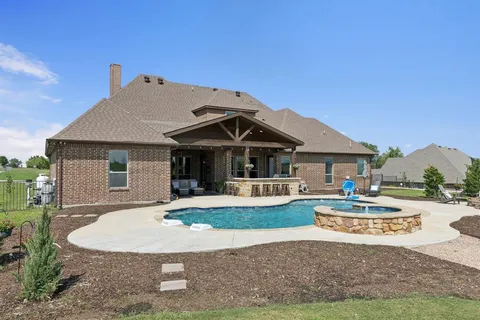 a view of a house with a yard and sitting area