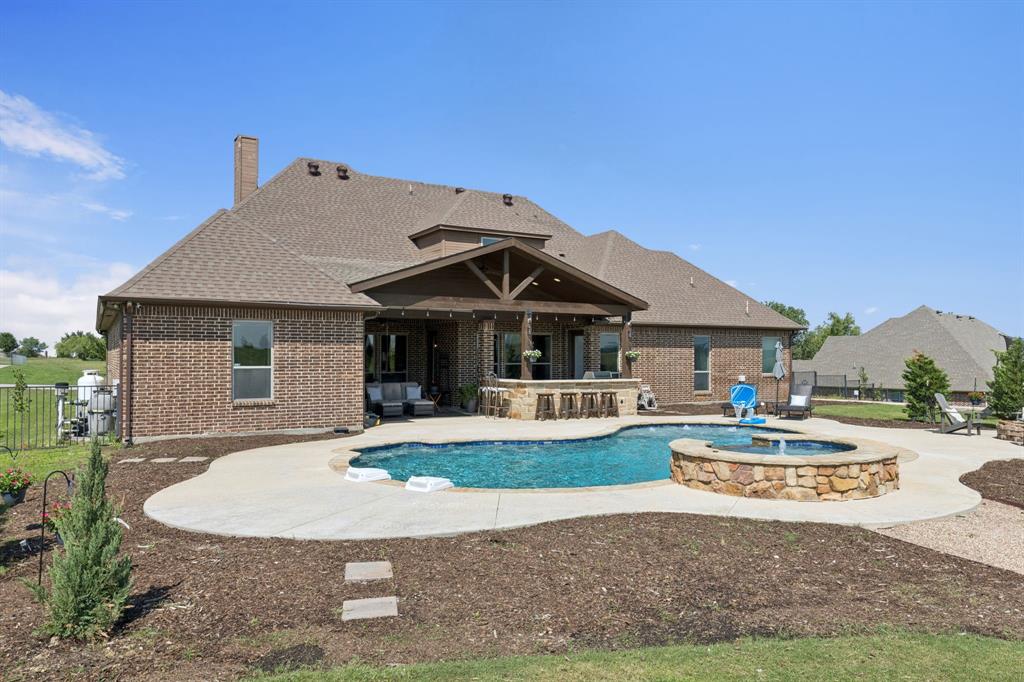 6824 Katie Corral Drive Fort Worth, TX 76126 - Photo 36 of 39 a front view of a house with a yard table and chairs