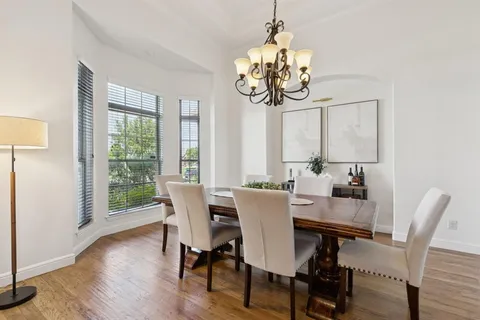 a view of a dining room with furniture wooden floor and chandelier