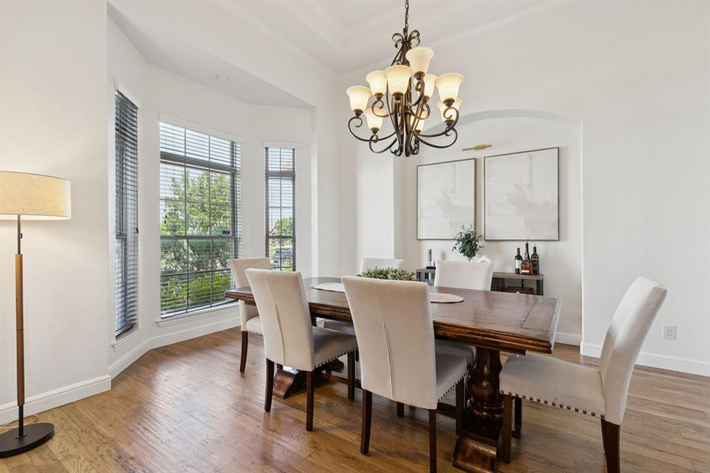6824 Katie Corral Drive Fort Worth, TX 76126 - Photo 4 of 39 a view of a dining room with furniture wooden floor and chandelier