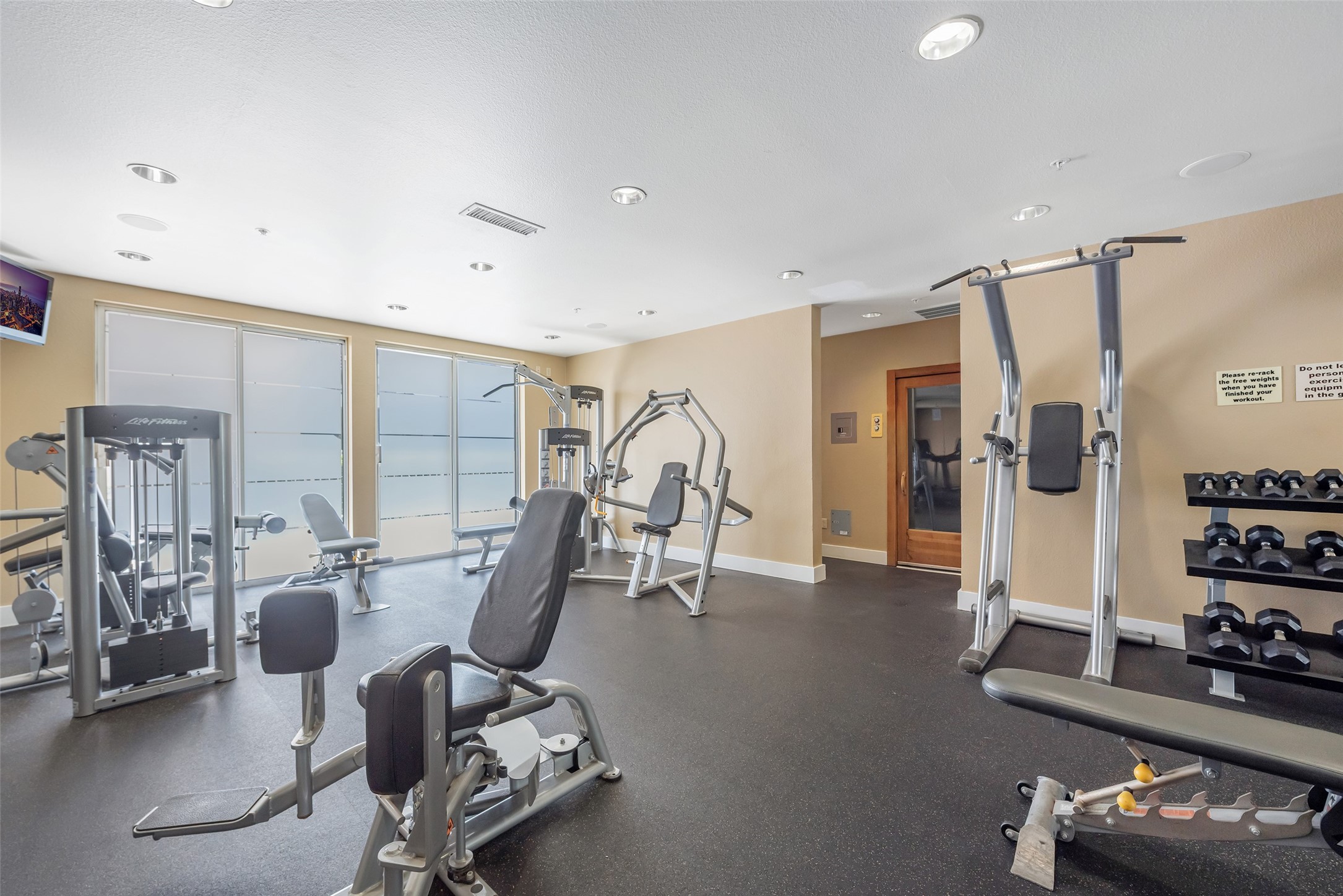 3505 Sage Road, Unit 2210 Houston, TX 77056 - Photo 28 of 40 Bright and airy, the gym features a full range of cardio machines, weights, and equipment—perfect for every workout.