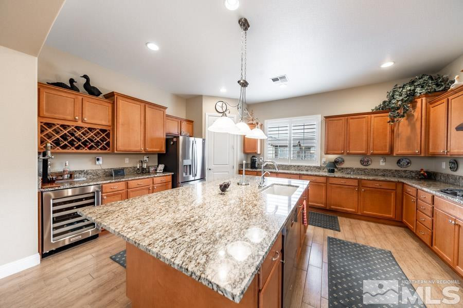 2210 Trakehner Lane Reno, NV 89521 - Photo 11 of 39 a large kitchen with kitchen island a large counter space a sink stainless steel appliances and cabinets