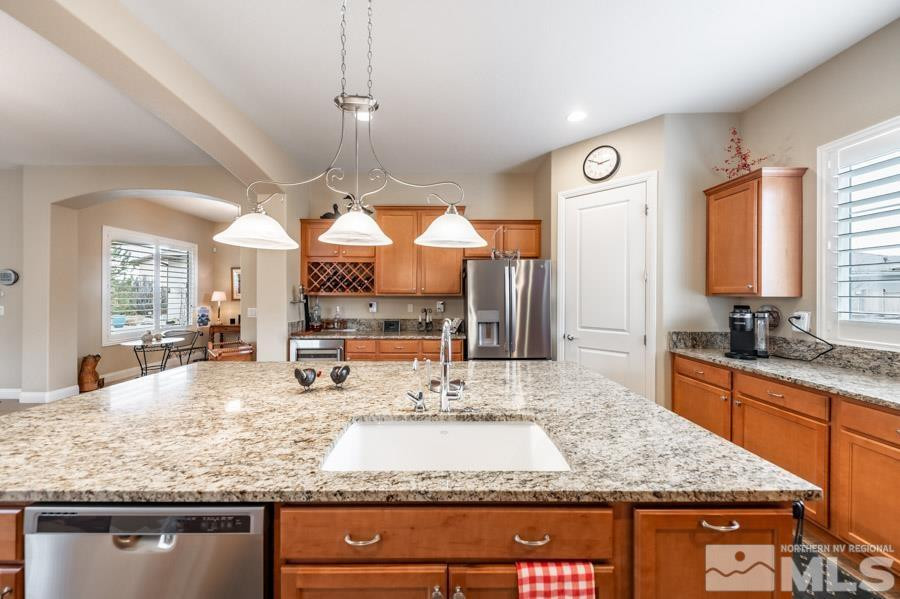 2210 Trakehner Lane Reno, NV 89521 - Photo 13 of 39 a kitchen with kitchen island granite countertop a large center island and a large window
