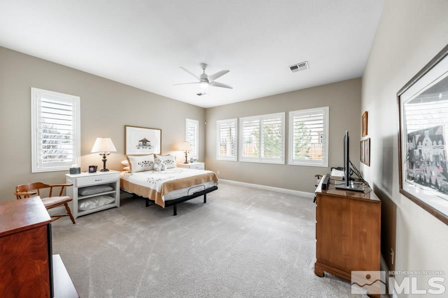2210 Trakehner Lane Reno, NV 89521 - Photo 17 of 39 a spacious bedroom with a bed and wooden floor