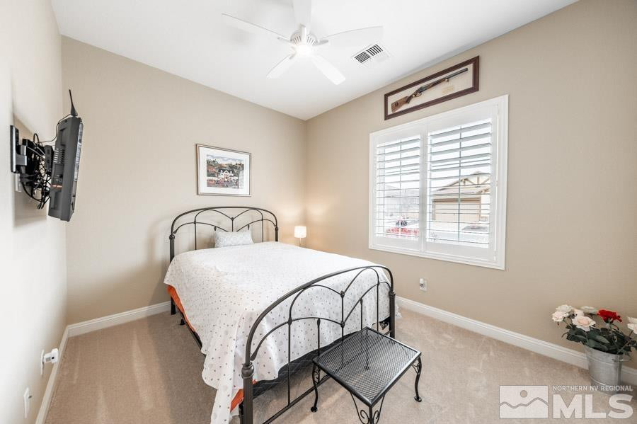 2210 Trakehner Lane Reno, NV 89521 - Photo 25 of 39 a bedroom with a bed and a window