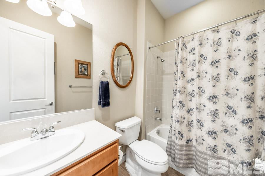 2210 Trakehner Lane Reno, NV 89521 - Photo 26 of 39 a white toilet sitting next to a bathroom sink
