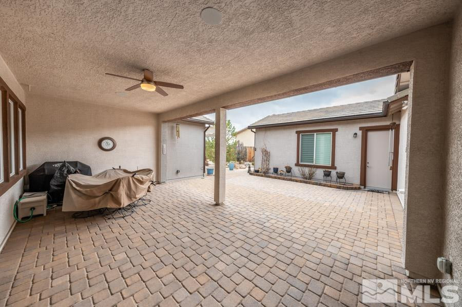 2210 Trakehner Lane Reno, NV 89521 - Photo 27 of 39 a spacious bedroom with a bed and a chandelier
