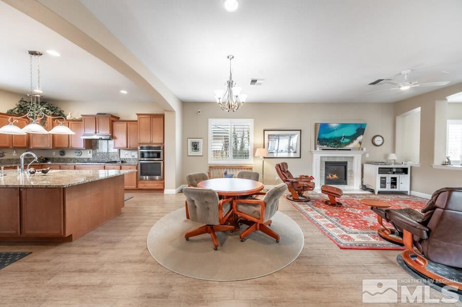2210 Trakehner Lane Reno, NV 89521 - Photo 5 of 39 a living room with granite countertop kitchen view and a dining table with kitchen view