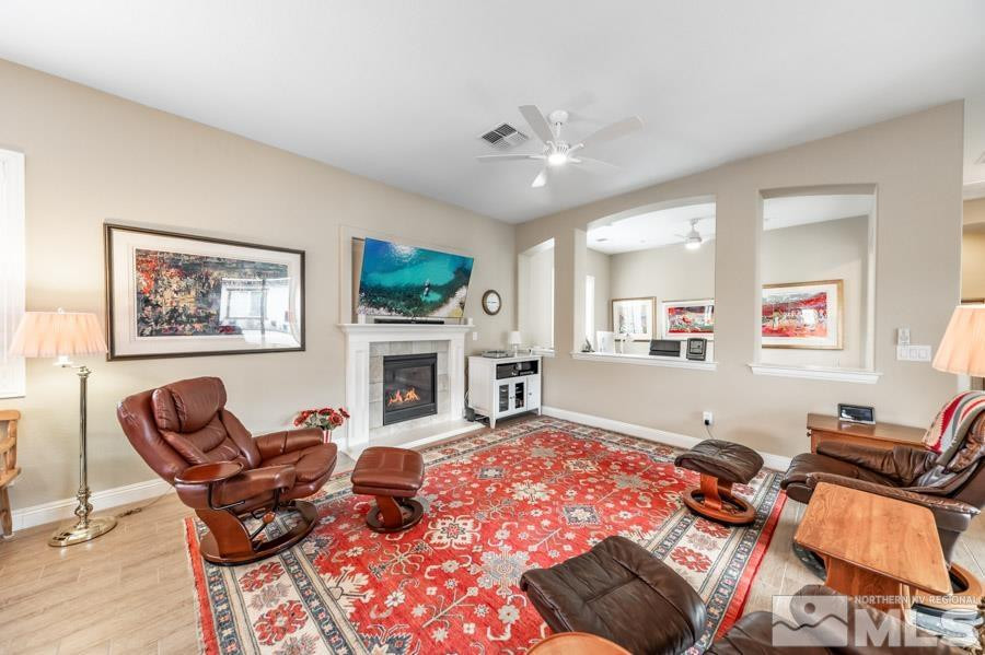 2210 Trakehner Lane Reno, NV 89521 - Photo 7 of 39 a living room with furniture a fireplace and a flat screen tv