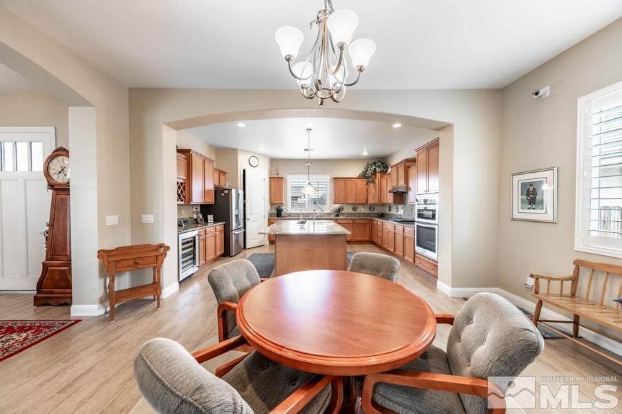 2210 Trakehner Lane Reno, NV 89521 - Photo 10 of 39 a dining room with furniture a chandelier and wooden floor