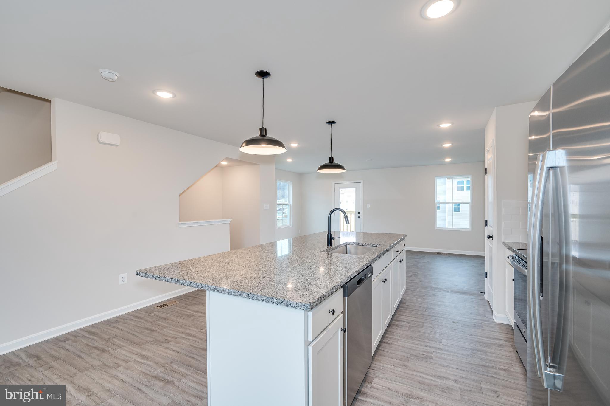 164 Rabbit Road Hedgesville, WV 25427 - Photo 27 of 41 a kitchen with stainless steel appliances granite countertop a sink a refrigerator and a counter top