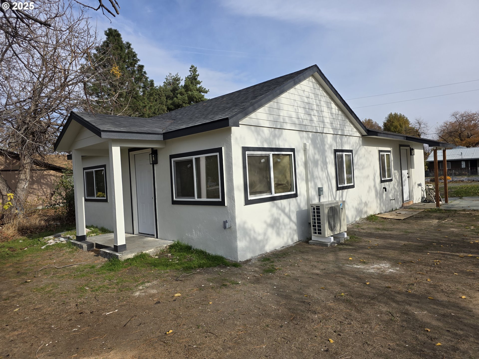 310 4th Street Northeast Irrigon, OR 97844 - Photo 2 of 13 a front view of a house with a yard