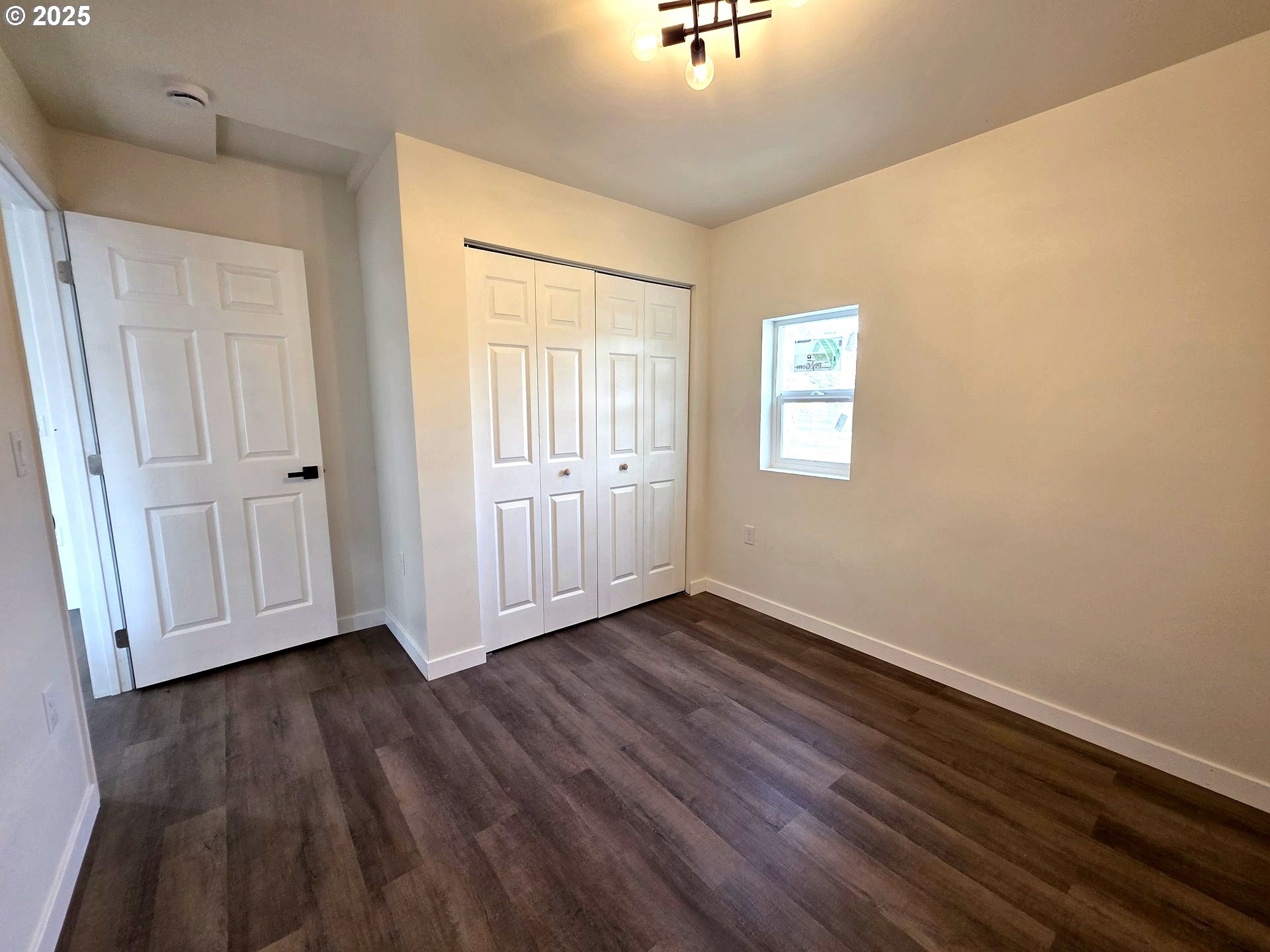 310 4th Street Northeast Irrigon, OR 97844 - Photo 9 of 13 a view of an empty room with wooden floor and a window