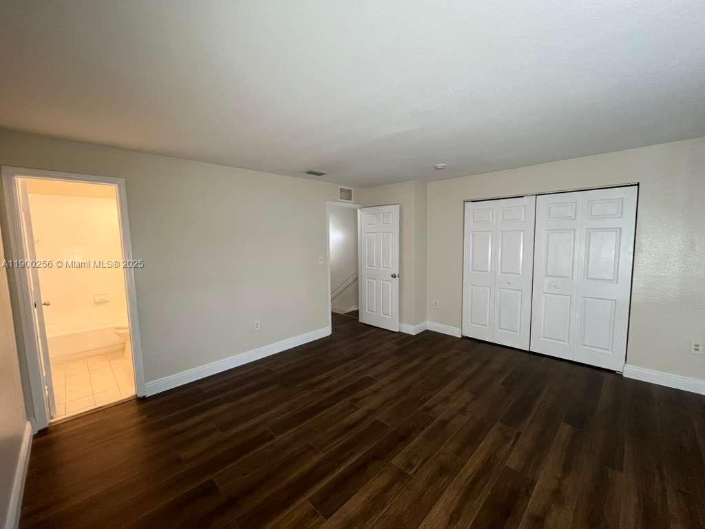 2271 Northwest 136th Terrace, Unit 2271 Opa-Locka, FL 33054 - Photo 16 of 23 a view of an empty room and wooden floor