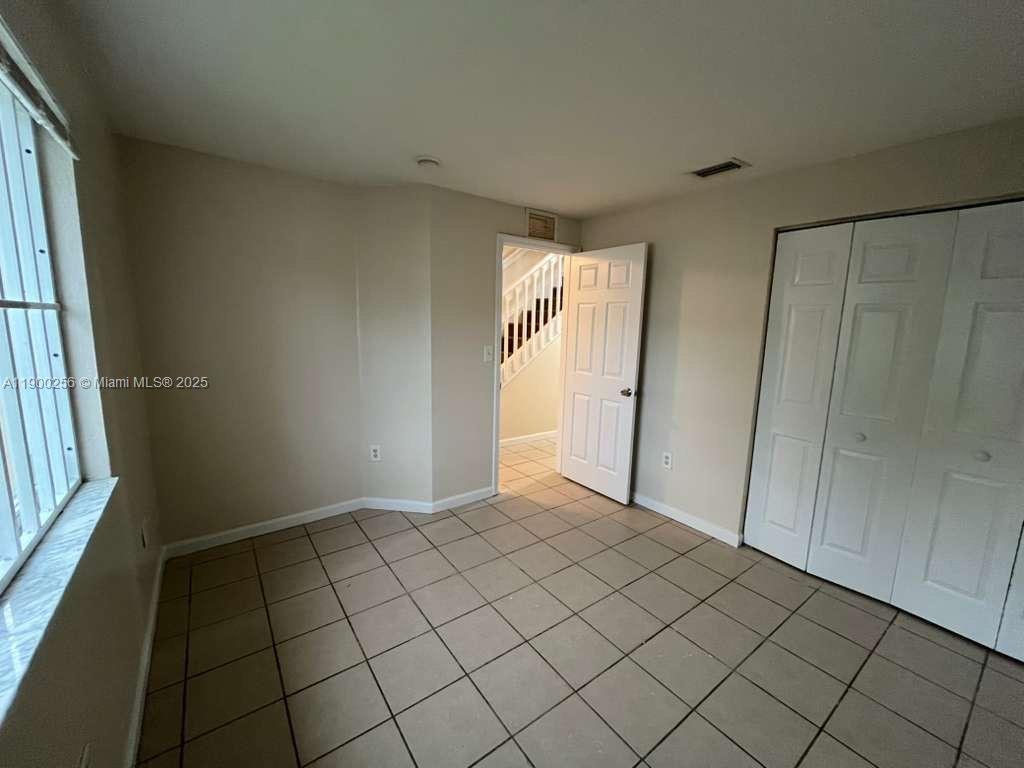 2271 Northwest 136th Terrace, Unit 2271 Opa-Locka, FL 33054 - Photo 8 of 23 a view of an empty room and window