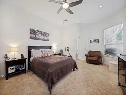 a bedroom with a bed and a couch