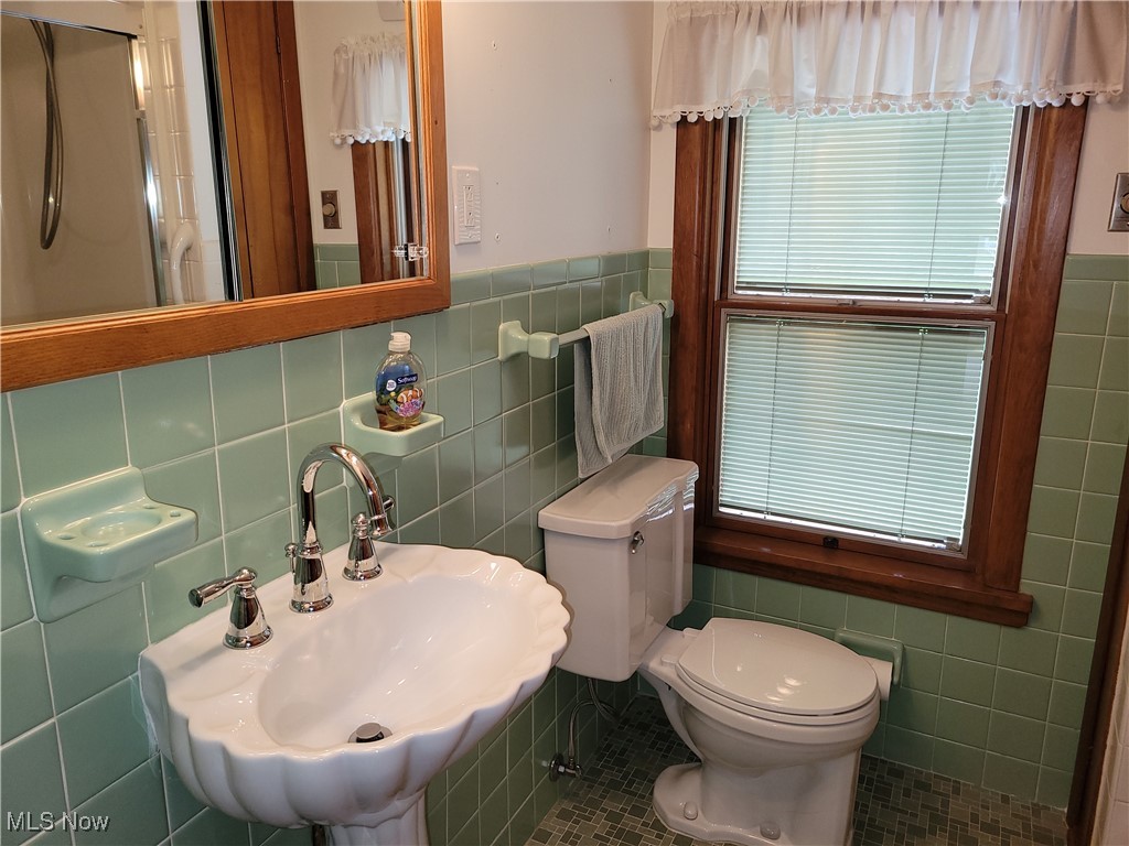 29119 Edgewood Road Bay Village, OH 44140 - Photo 28 of 40 Bathroom with tile walls, wainscoting, and tile patterned flooring