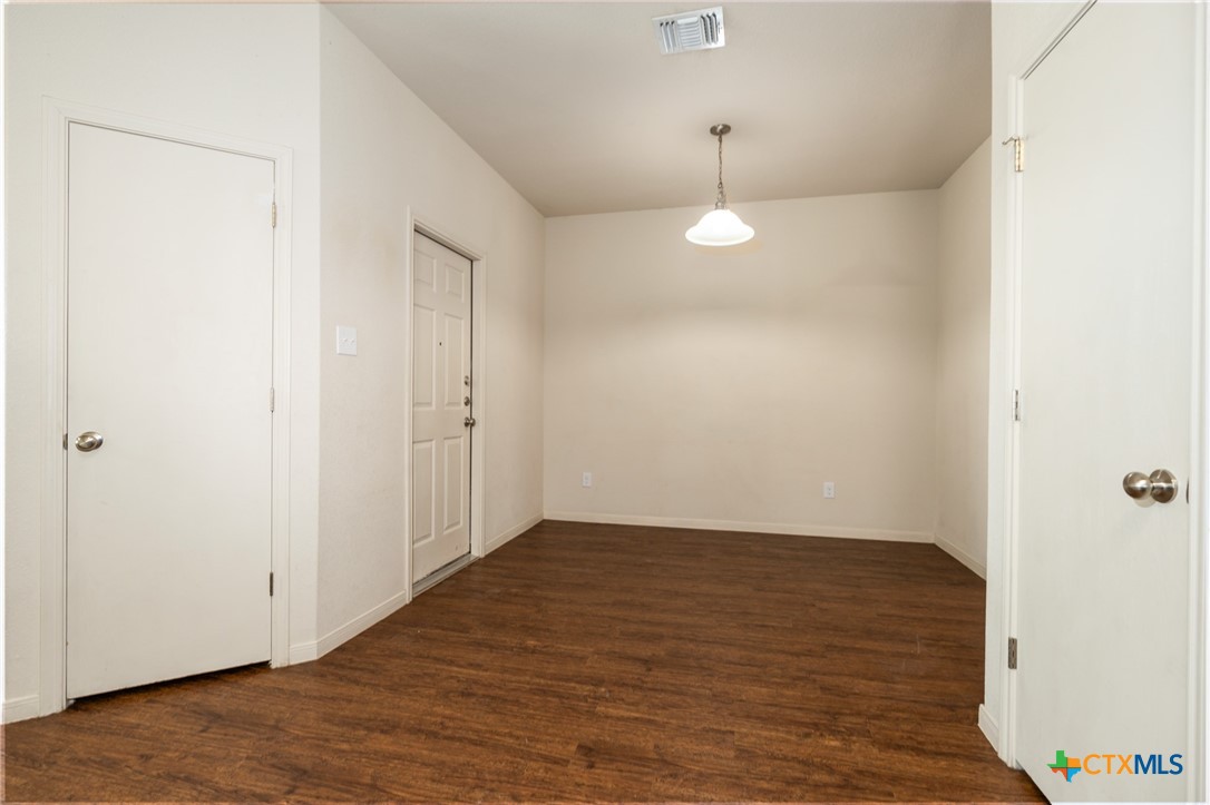 5701 Rustler Drive, Unit B Killeen, TX 76543 - Photo 15 of 29 an empty room with wooden floor and windows