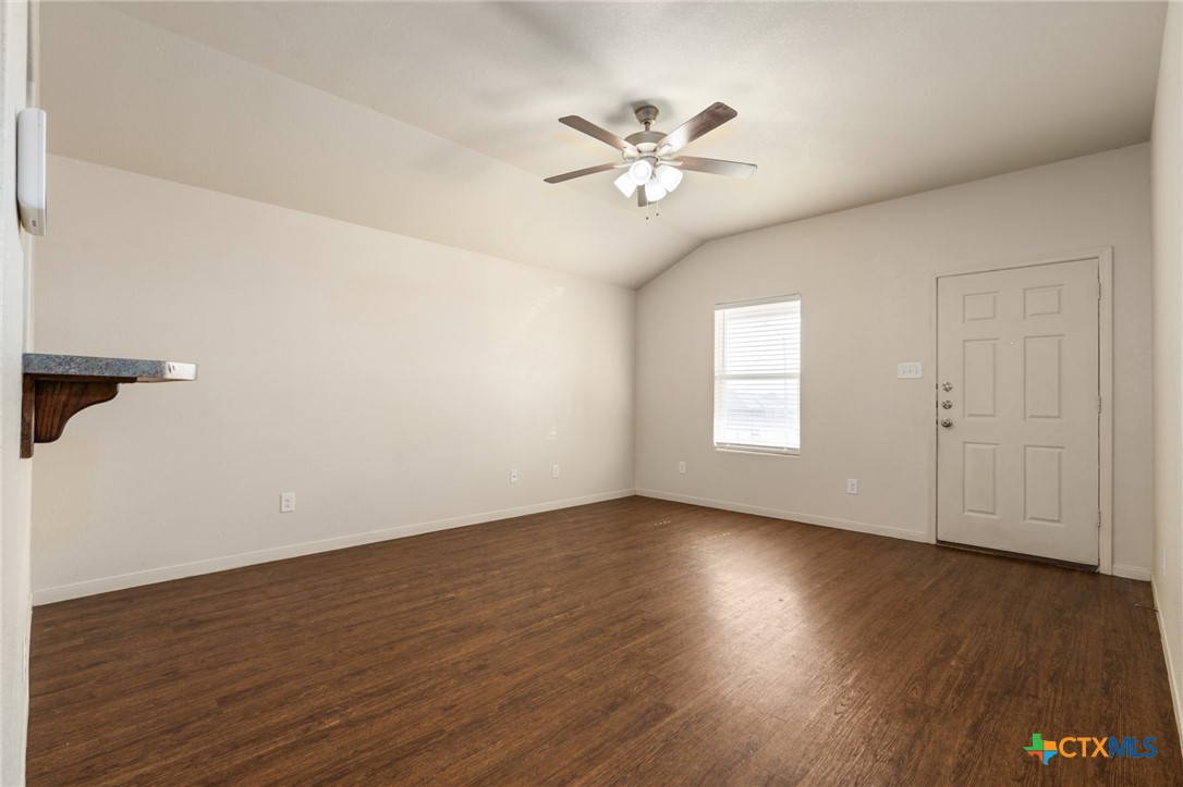 5701 Rustler Drive, Unit B Killeen, TX 76543 - Photo 5 of 29 a view of an empty room with wooden floor and a window