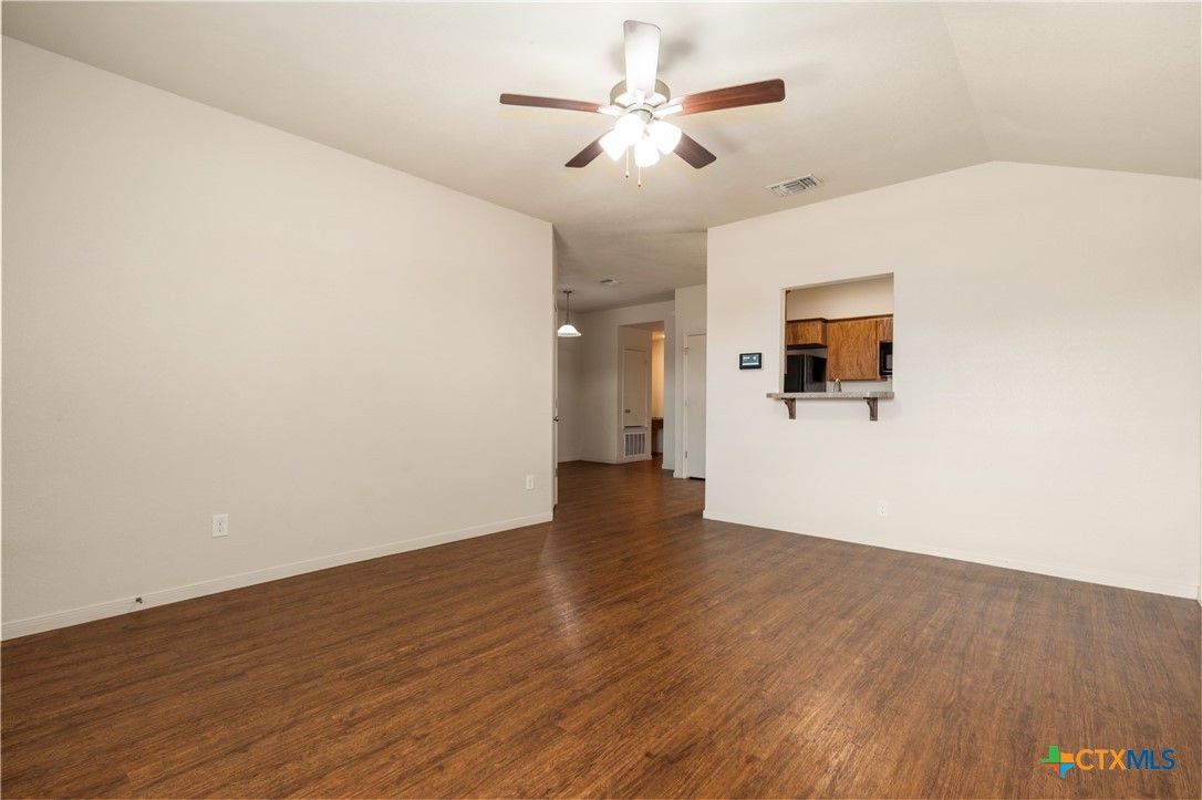 5701 Rustler Drive, Unit B Killeen, TX 76543 - Photo 6 of 29 a view of a livingroom with wooden floor and a ceiling fan
