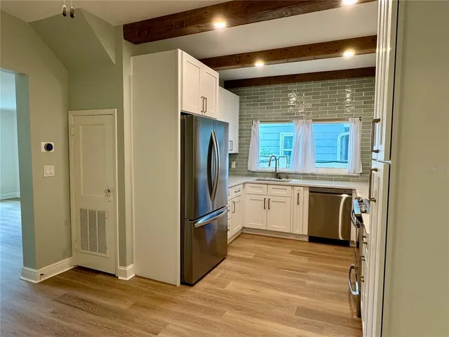a kitchen with a refrigerator and a sink
