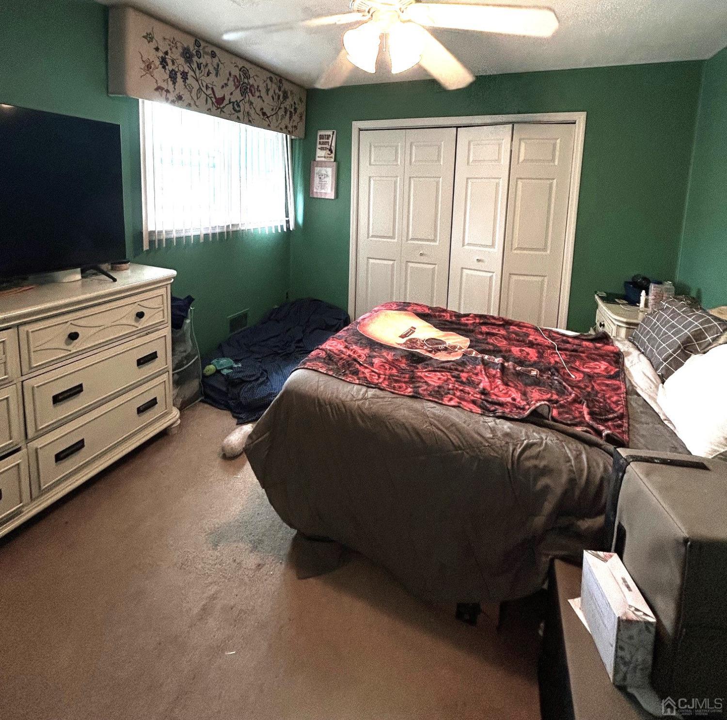 327 New Market Road Dunellen, NJ 08812 - Photo 12 of 13 a bedroom with a bed and flat tv screen on dresser