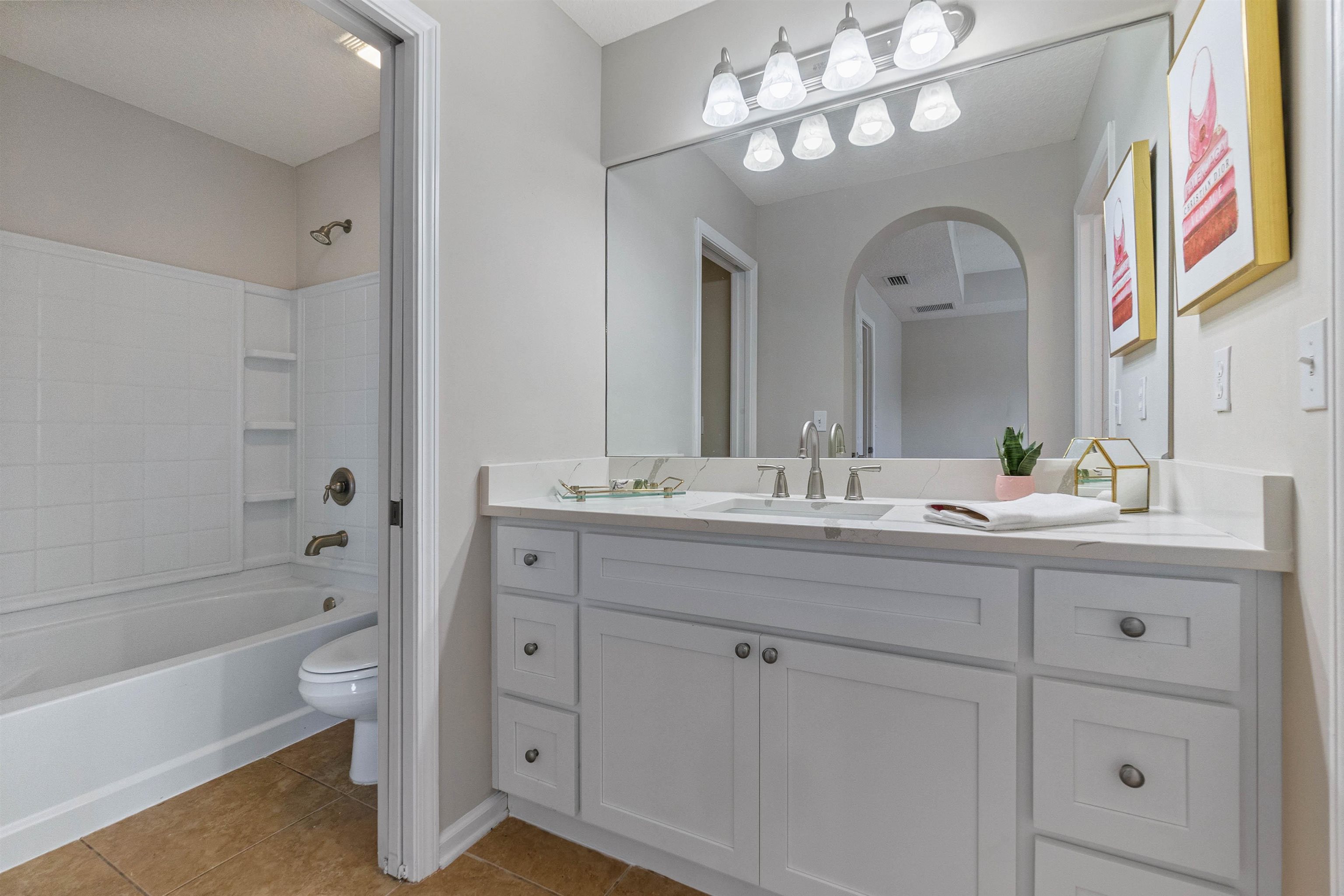 18 Amistad Drive St. Augustine, FL 32086 - Photo 18 of 37 a bathroom with a double vanity sink a toilet and a bathtub