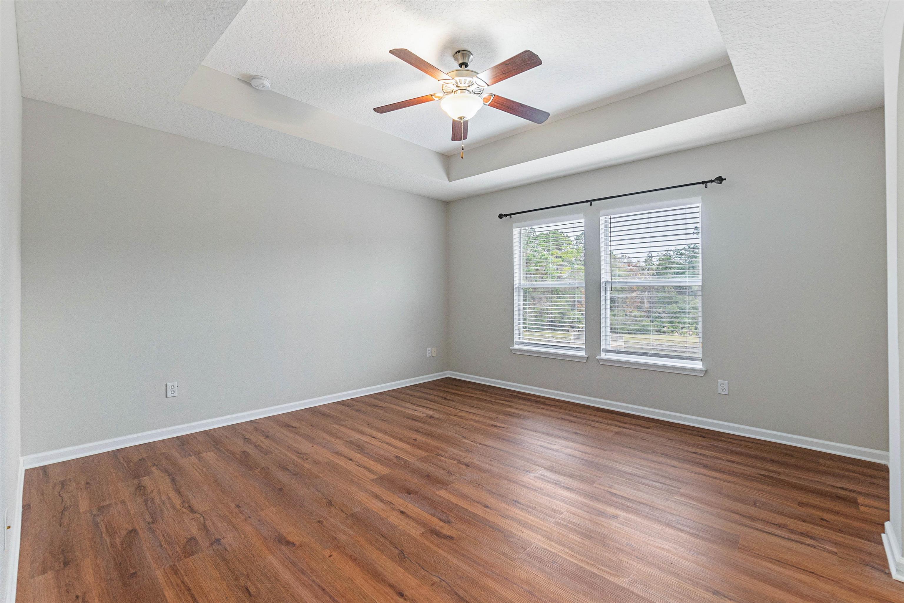 18 Amistad Drive St. Augustine, FL 32086 - Photo 20 of 37 wooden floor in an empty room with a window