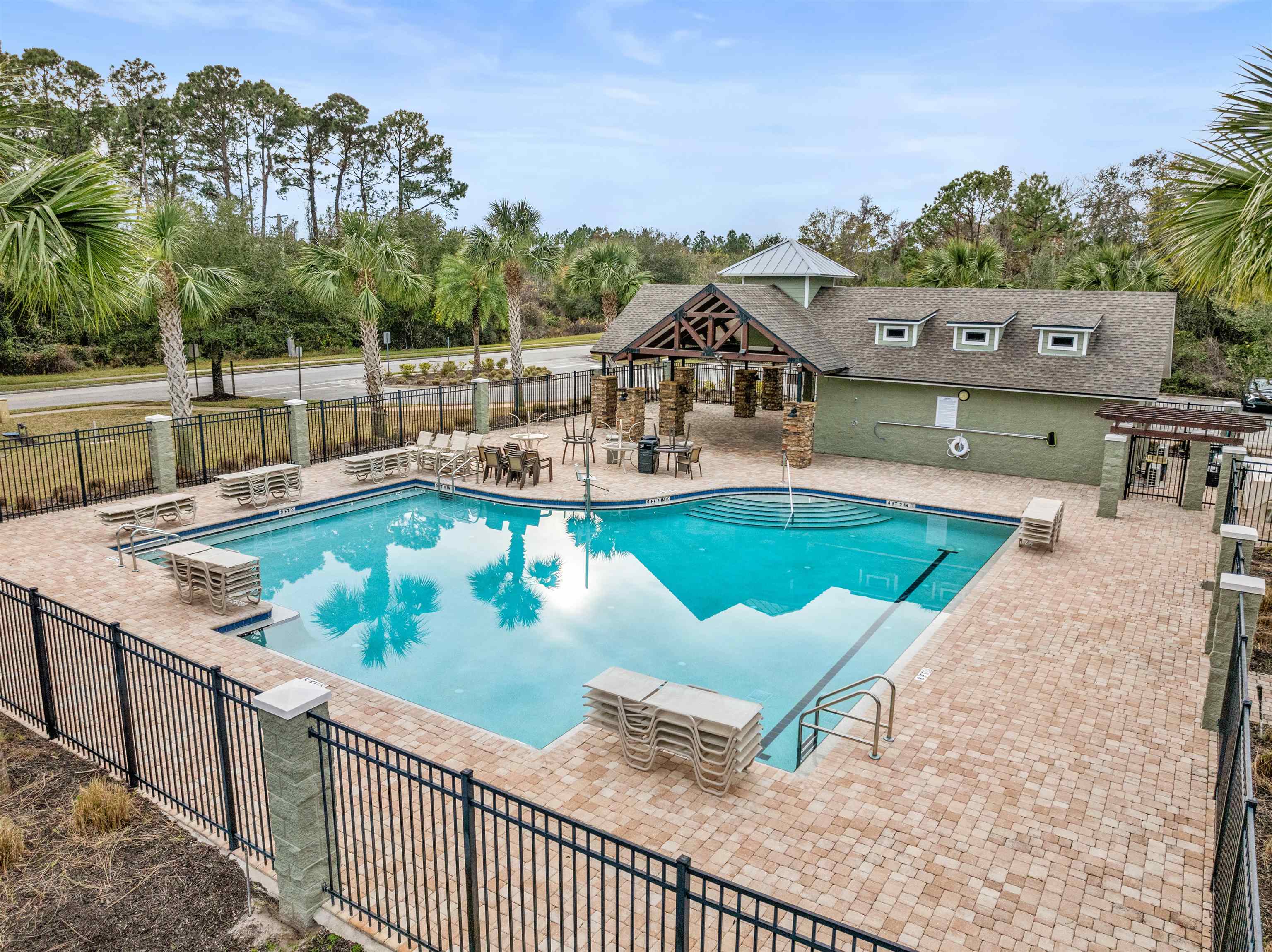 18 Amistad Drive St. Augustine, FL 32086 - Photo 30 of 37 a view of a swimming pool with a patio and a yard