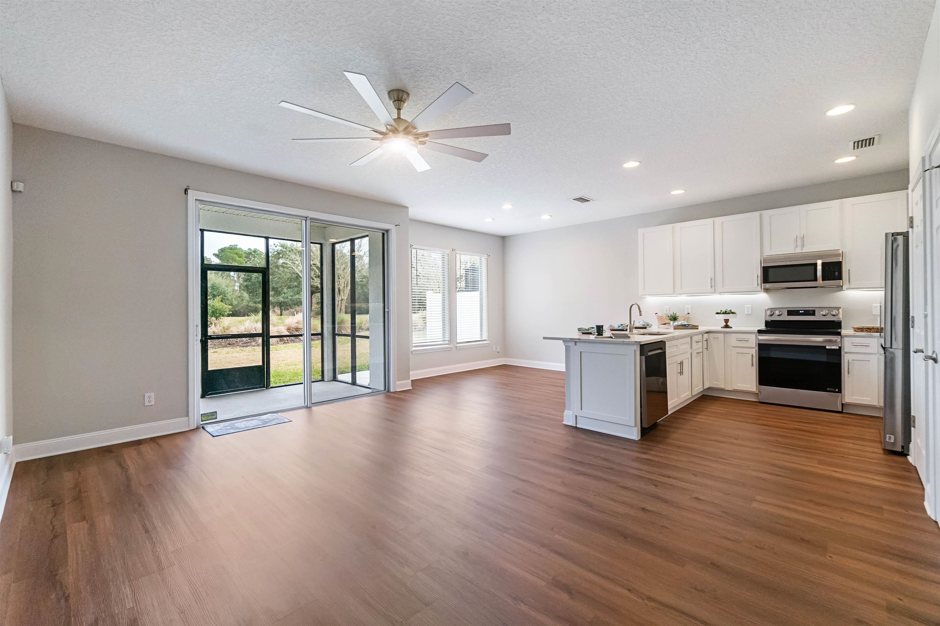 18 Amistad Drive St. Augustine, FL 32086 - Photo 7 of 37 a view of kitchen with granite countertop stainless steel appliances cabinets a sink and a wooden floor
