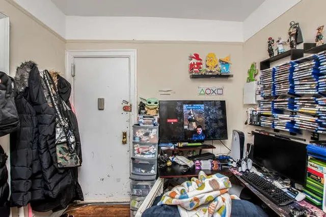 a bedroom with a bed and a flat screen tv