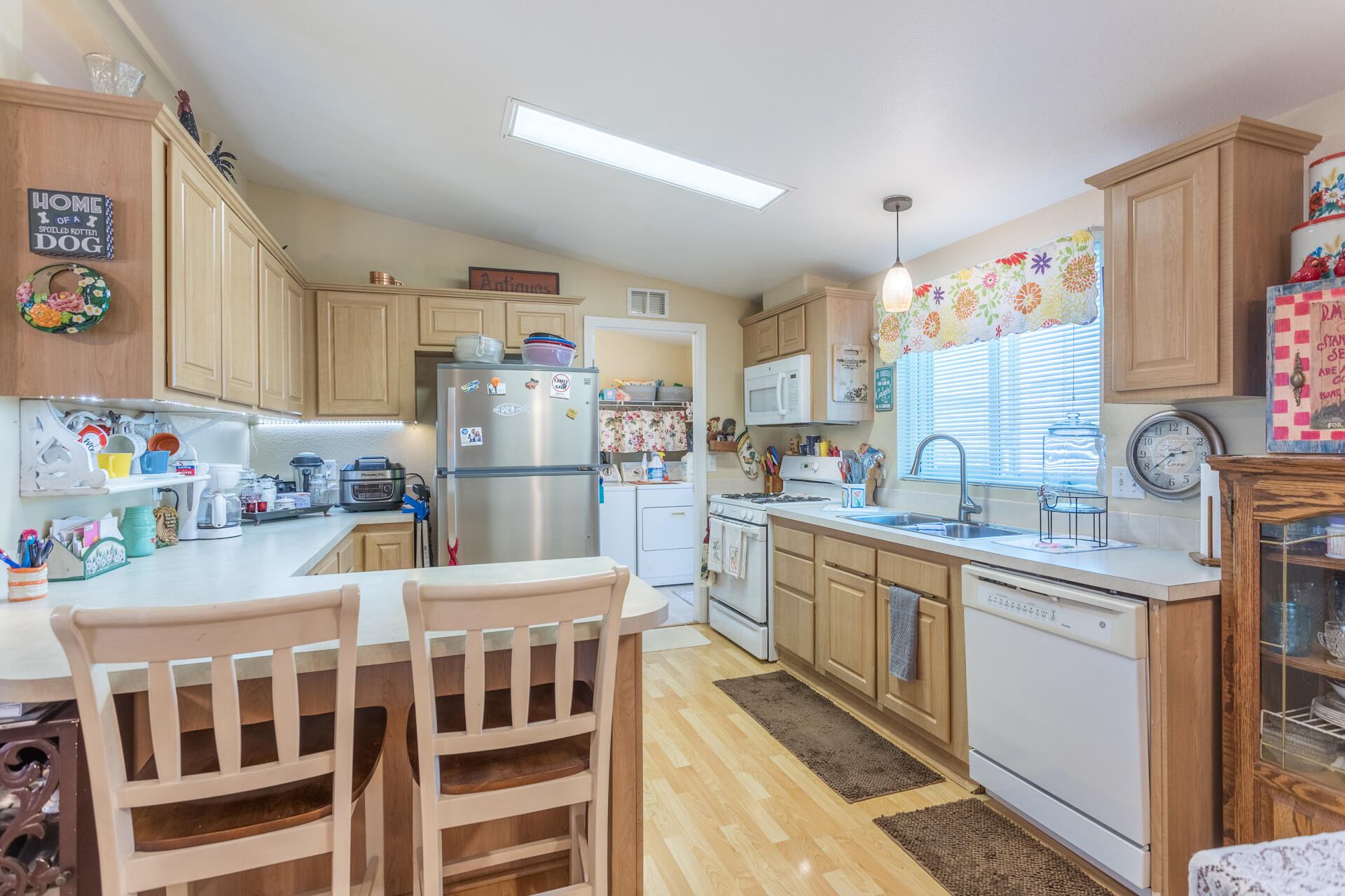 4696 Maple Trail, Unit LOS ROBLES ESTATES Redding, CA 96003 - Photo 11 of 33 a kitchen with granite countertop a sink stainless steel appliances and cabinets
