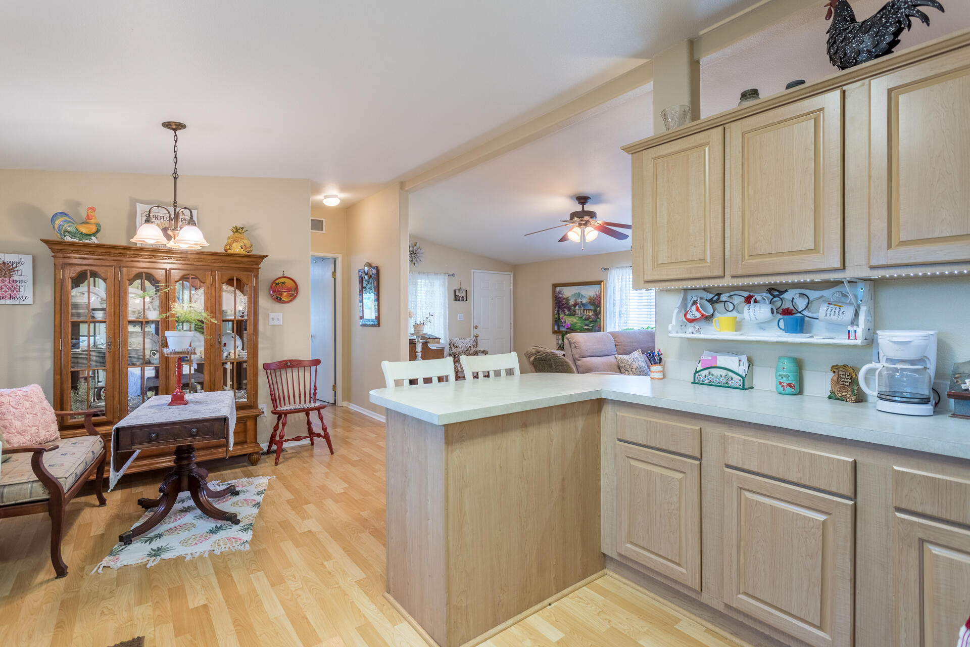 4696 Maple Trail, Unit LOS ROBLES ESTATES Redding, CA 96003 - Photo 12 of 33 a kitchen with a sink cabinets and wooden floor