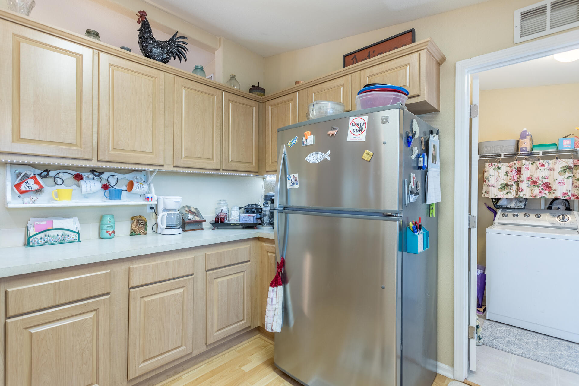 4696 Maple Trail, Unit LOS ROBLES ESTATES Redding, CA 96003 - Photo 13 of 33 a kitchen with refrigerator and cabinets
