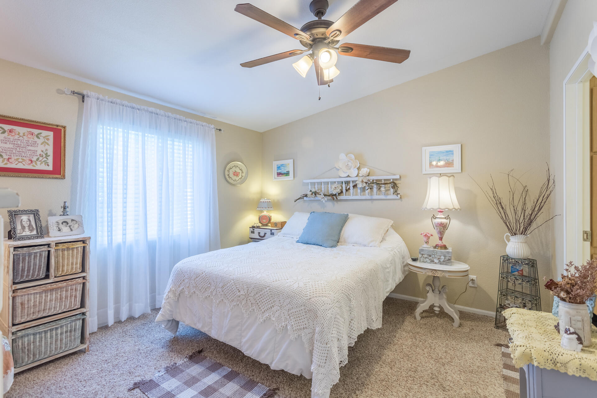 4696 Maple Trail, Unit LOS ROBLES ESTATES Redding, CA 96003 - Photo 15 of 33 a bedroom with a bed and a chandelier