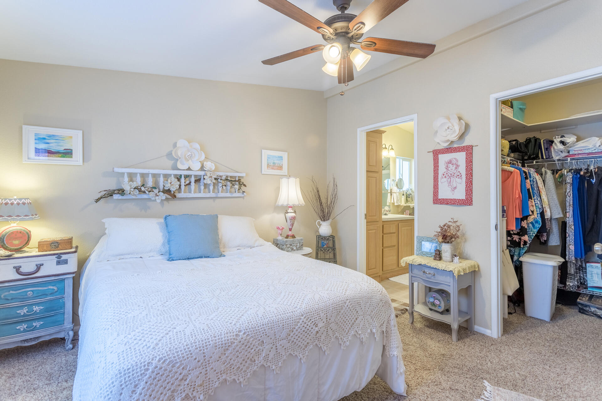 4696 Maple Trail, Unit LOS ROBLES ESTATES Redding, CA 96003 - Photo 16 of 33 a bedroom with a bed and a chandelier