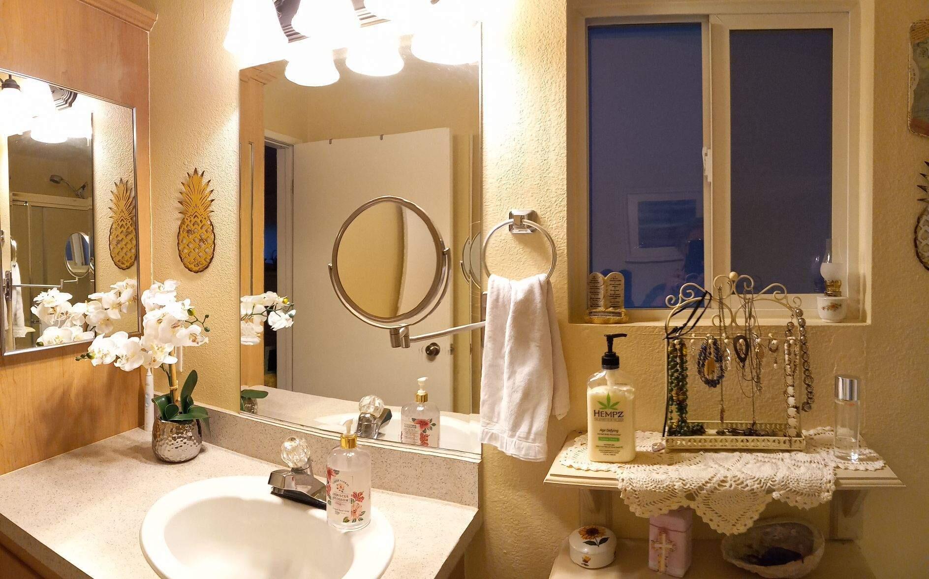4696 Maple Trail, Unit LOS ROBLES ESTATES Redding, CA 96003 - Photo 18 of 33 a bathroom with a sink and a mirror