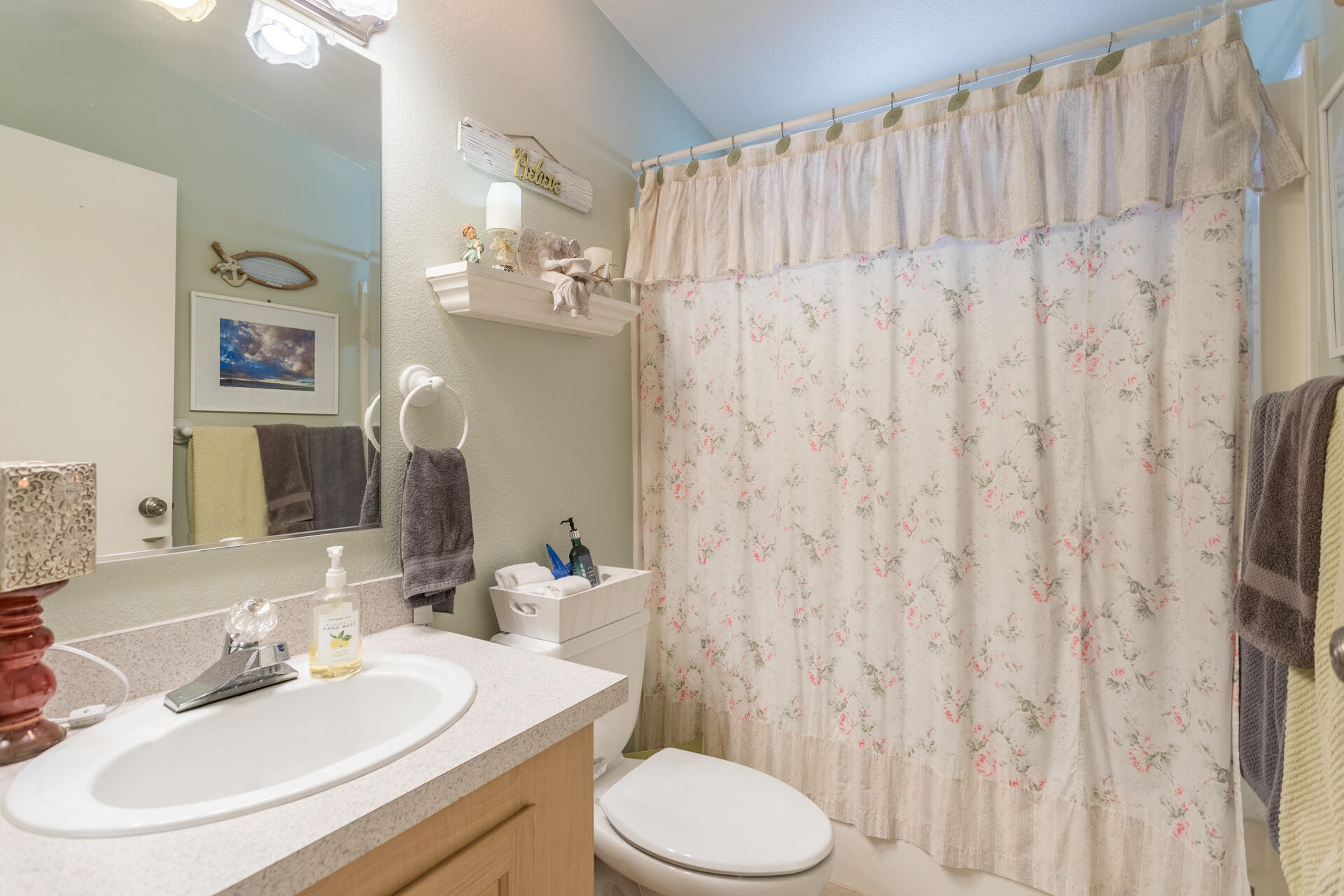 4696 Maple Trail, Unit LOS ROBLES ESTATES Redding, CA 96003 - Photo 22 of 33 a bathroom with a sink toilet and shower