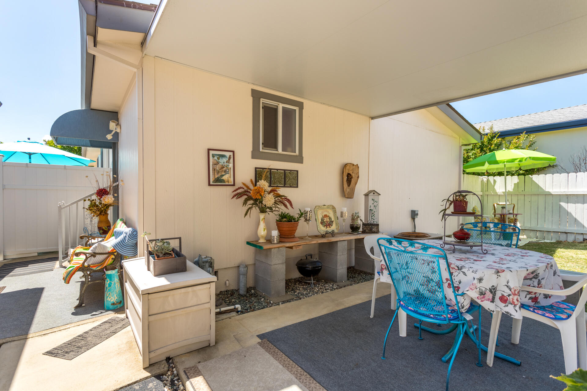 4696 Maple Trail, Unit LOS ROBLES ESTATES Redding, CA 96003 - Photo 28 of 33 a view of a dining room with furniture and a potted plant