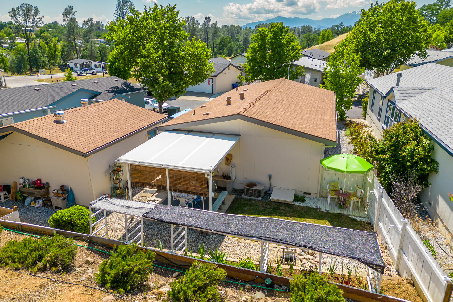 4696 Maple Trail, Unit LOS ROBLES ESTATES Redding, CA 96003 - Photo 3 of 33 an aerial view of a house with a yard potted plants and large tree