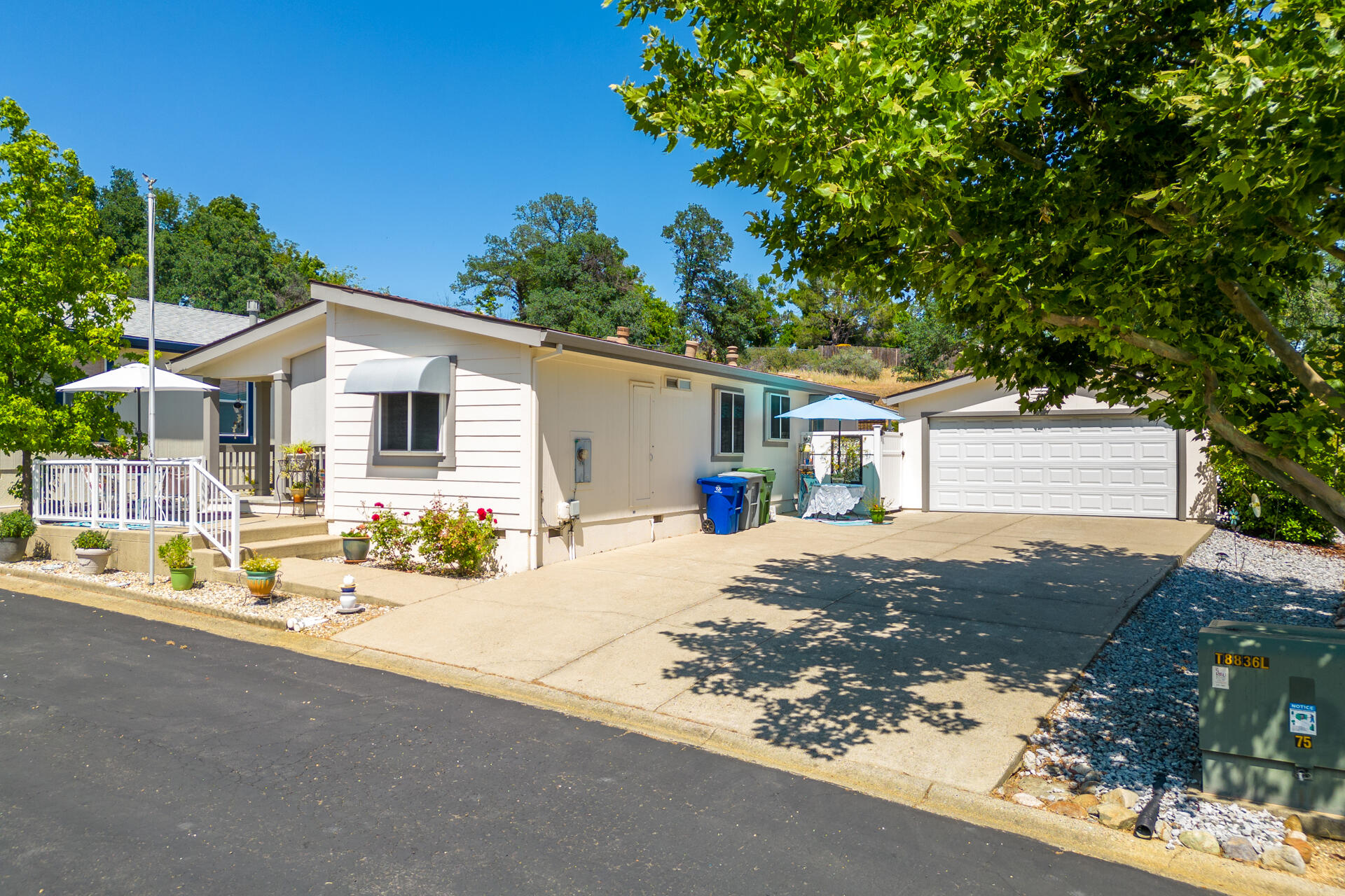 4696 Maple Trail, Unit LOS ROBLES ESTATES Redding, CA 96003 - Photo 32 of 33 a view of a house with backyard and sitting area