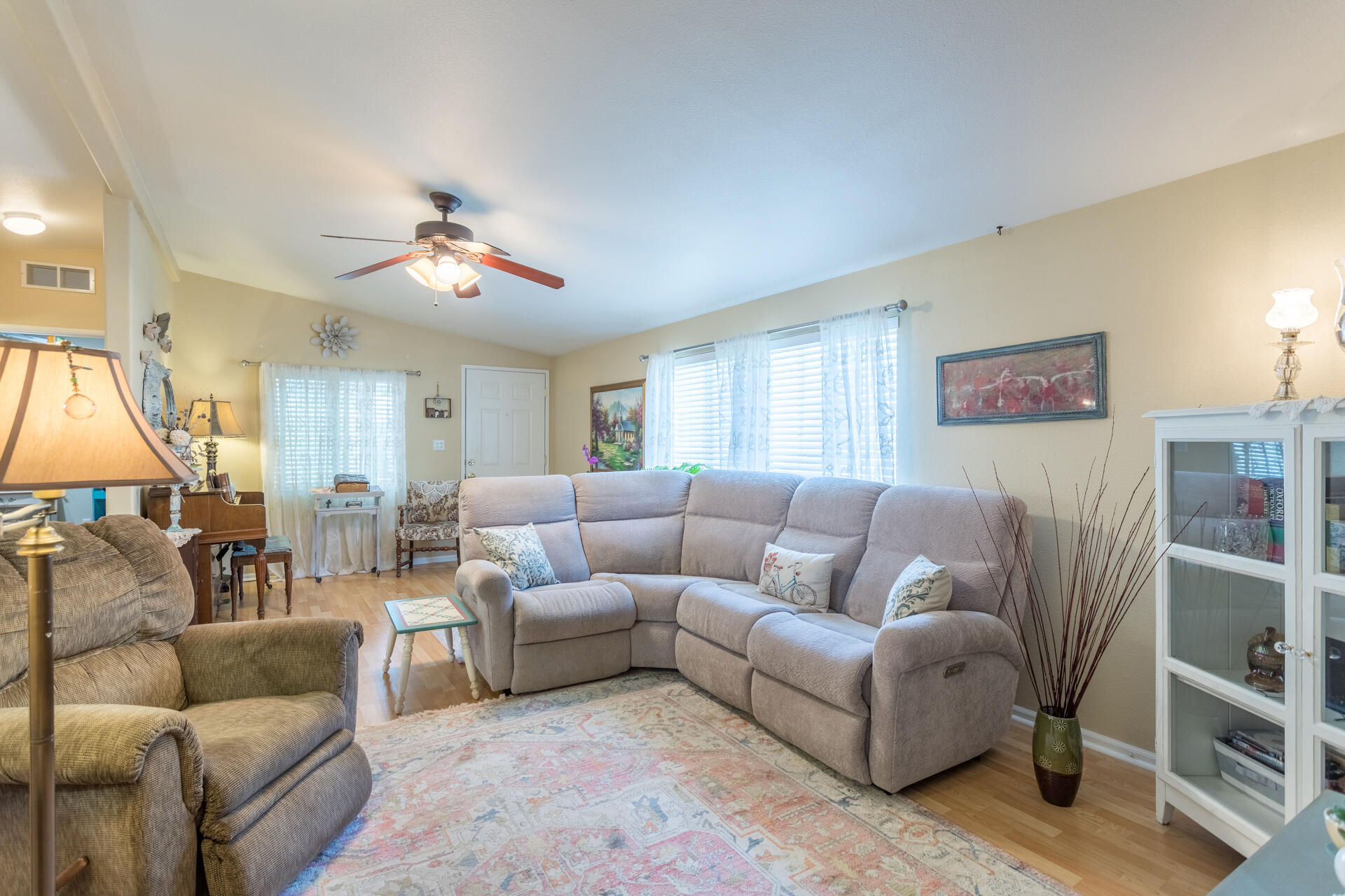 4696 Maple Trail, Unit LOS ROBLES ESTATES Redding, CA 96003 - Photo 8 of 33 a living room with furniture a lamp and a window