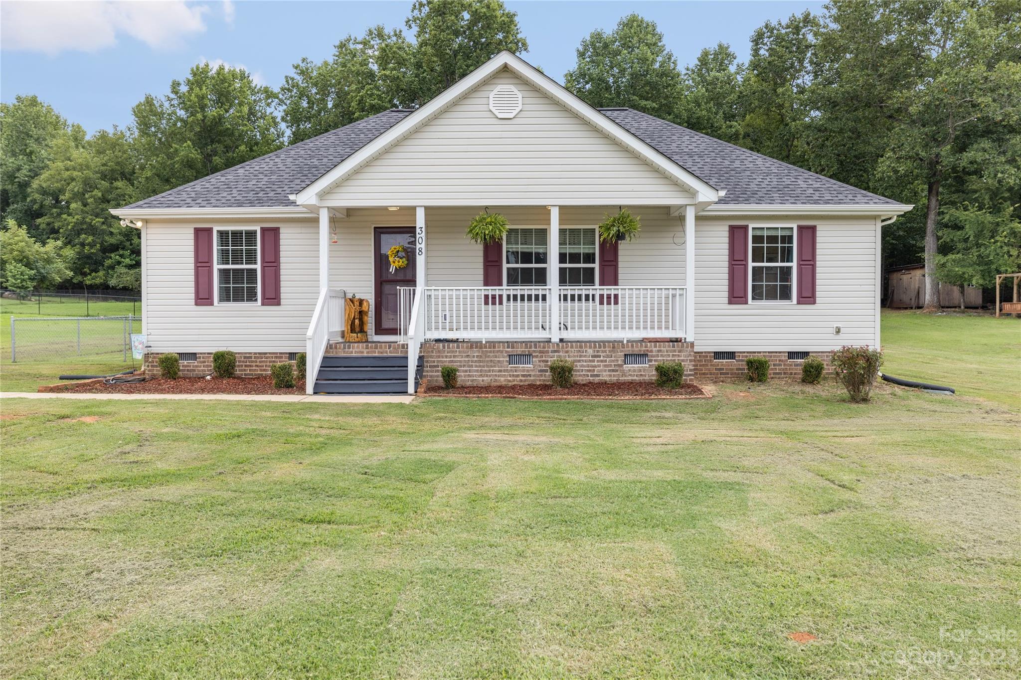 308 Fleetwood Road York, SC 29745 - Photo 1 of 25 a front view of a house with a garden and yard
